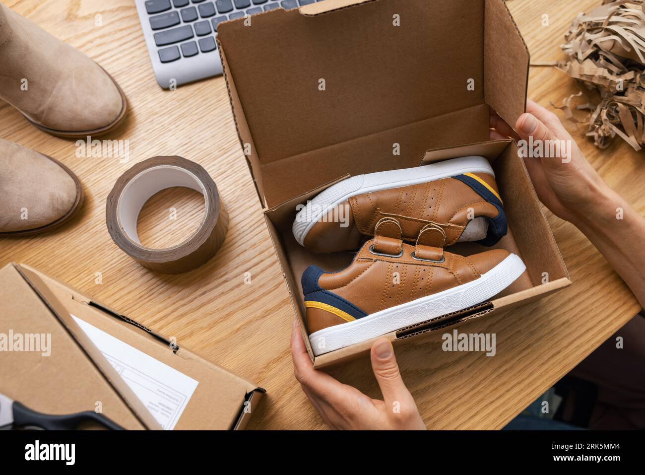 selling online, internet shoe store owner, small business entrepreneur working at home office and packing order parcel for delivery Stock Photo