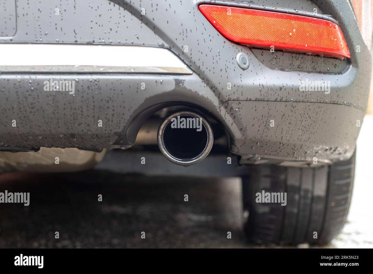 Close up, exhaust pipe of family car. Rear bumper of a car with exhaust pipe Stock Photo