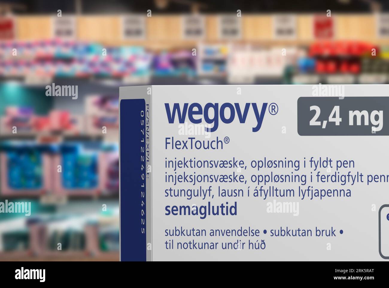 Packaging box of Wegovy (semaglutide) injectable prescription medication, weight-loss drug from Novo Nordisk A/S.  Blurred shop shelves in background. Stock Photo