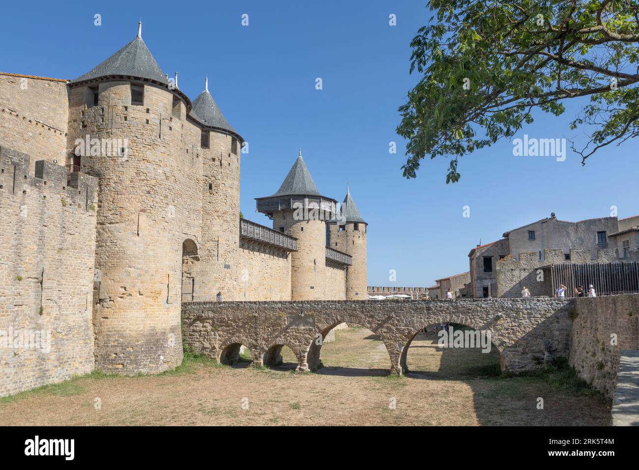 Tourists crossing a bridge to the ramparts of Carcassonne Citadel Stock Photo