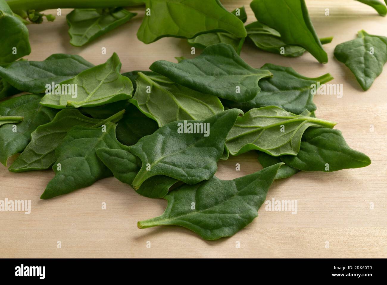 Fresh raw New Zealand spinach leaves on a cutting board close up Stock Photo