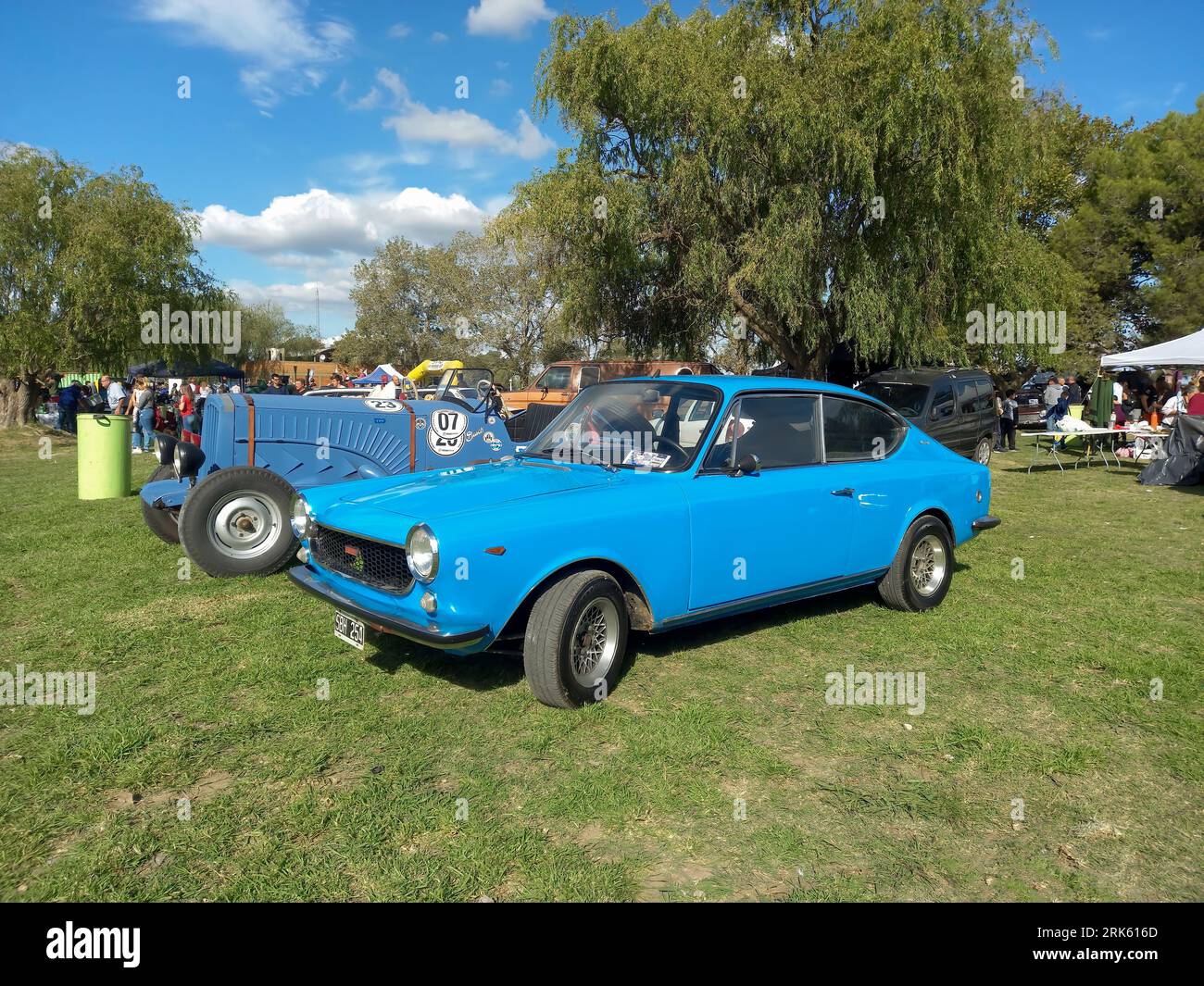 Old aqua blue 1972 Fiat 125 Sport coupe fastback berlinetta on the lawn. Nature, grass, trees. CAACMACH 2023 classic car show. Copyspace. Sunny day Stock Photo