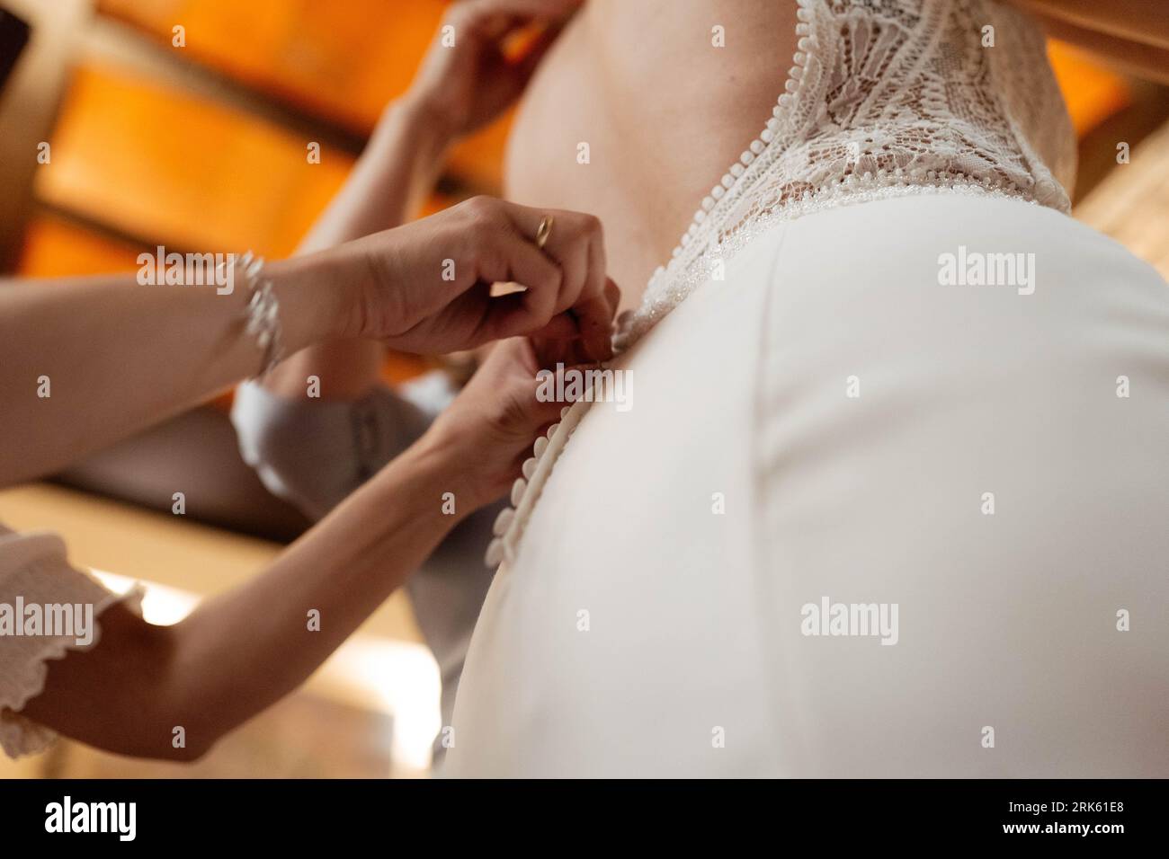 A young woman wearing a white bridal gown with intricate details Stock Photo
