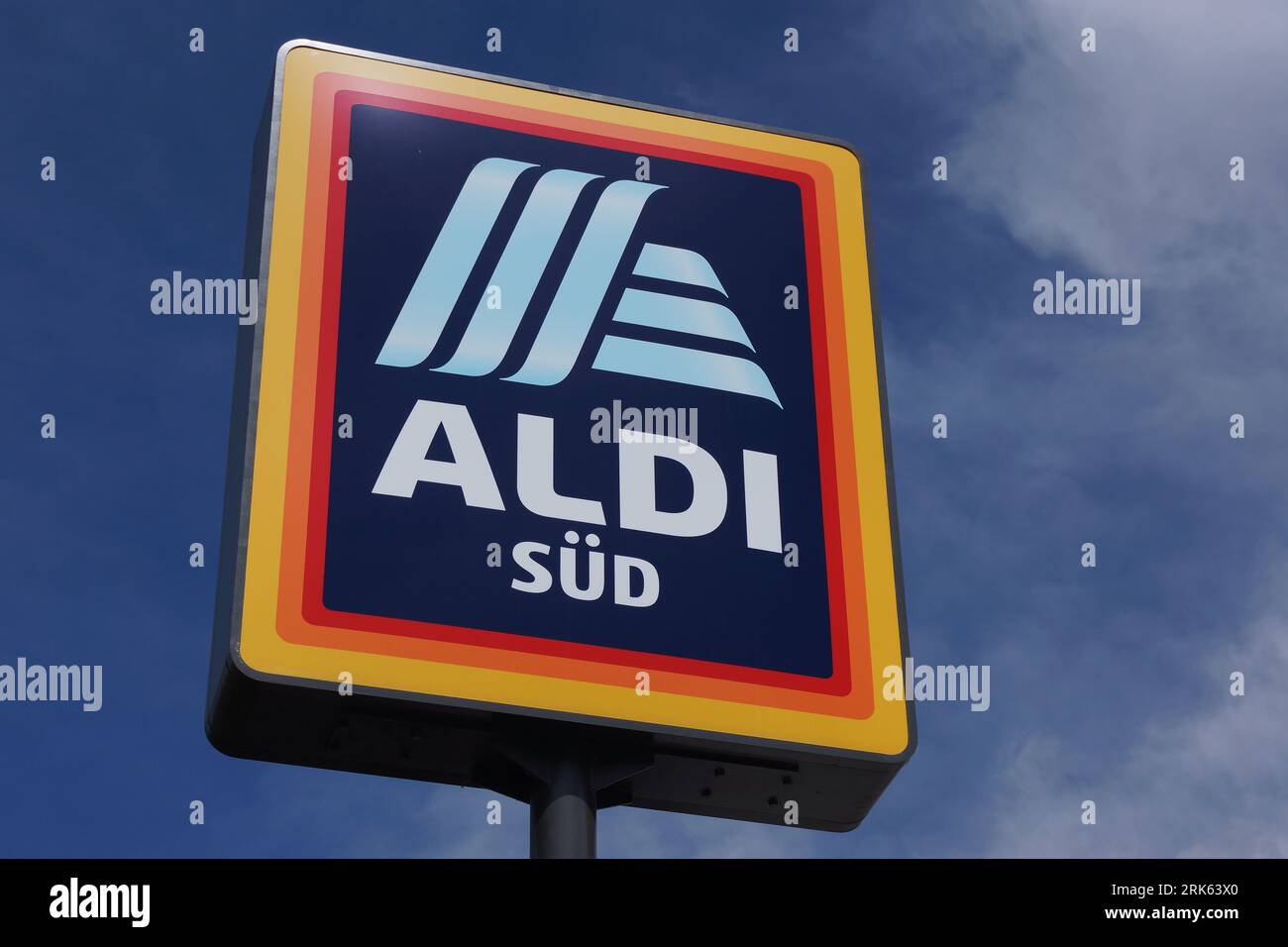 The Aldi Sued Logo In Front Of A Supermarket Against A Blue And White 