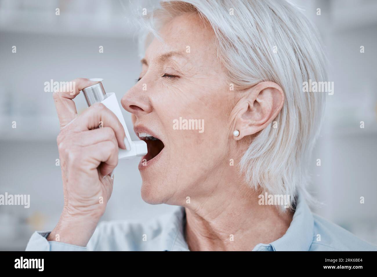 Senior woman, asthma inhaler and pump for pharmaceutical product, health and care. Elderly patient, breathe and spray for oxygen, wellness and Stock Photo