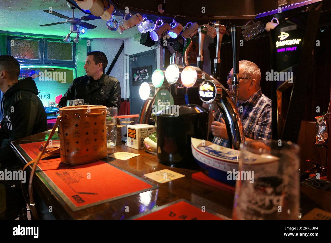 People watching a big sporting event on the TV in a local pub Stock