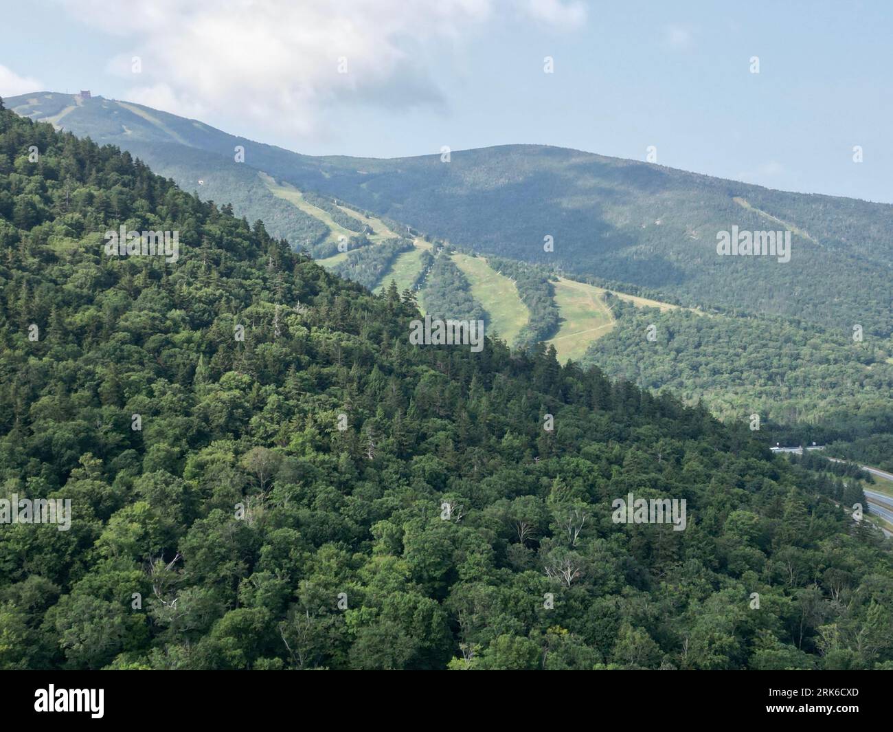 A scenic view of lush green mountains in a valley Stock Photo - Alamy