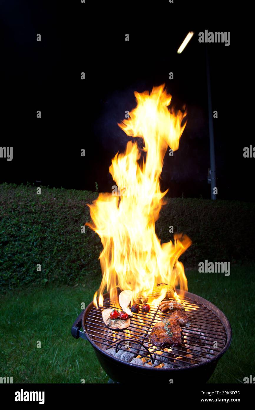 flames on a kettle grill Stock Photo