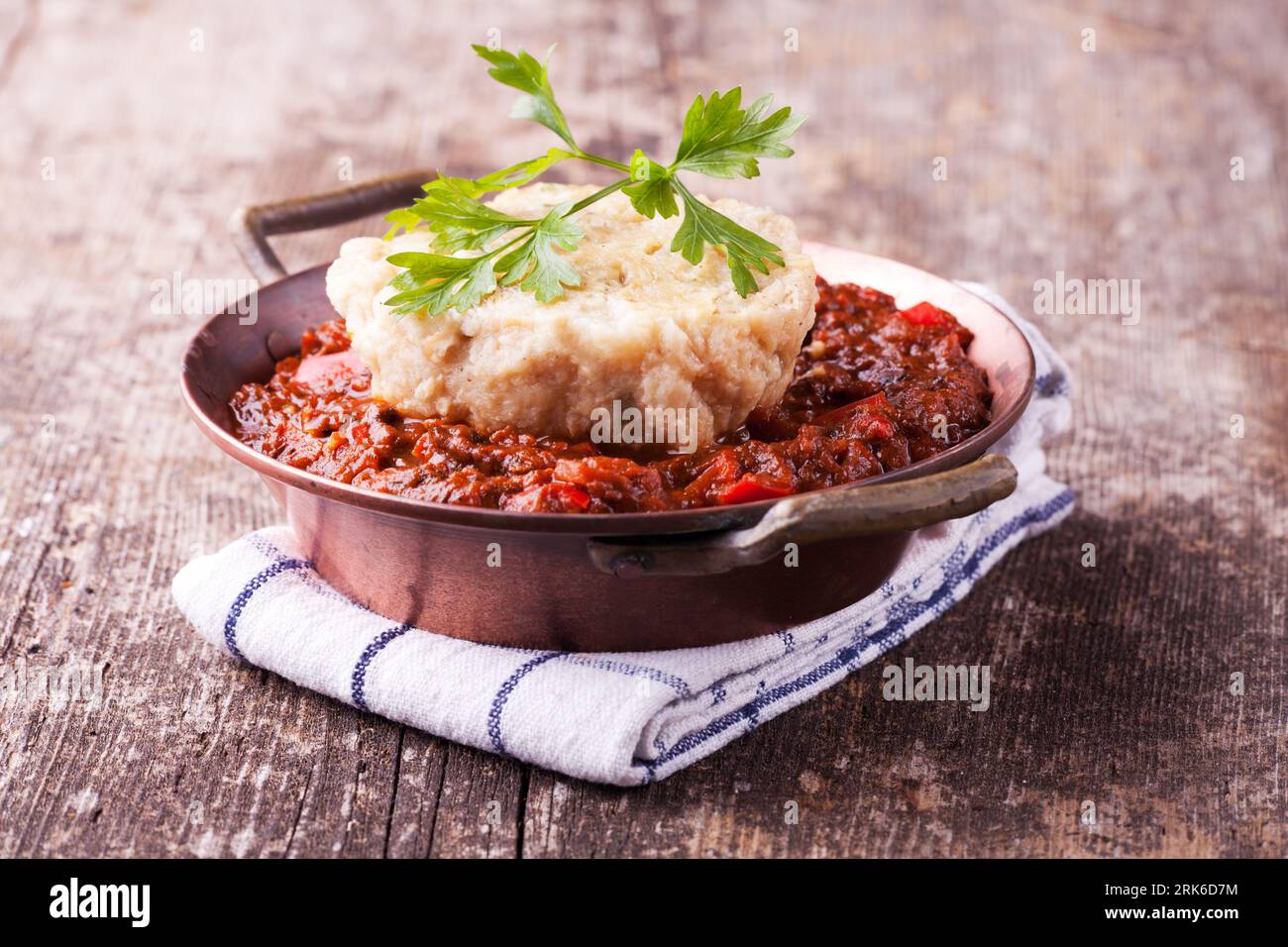 goulash with dumpling on a wooden plank Stock Photo