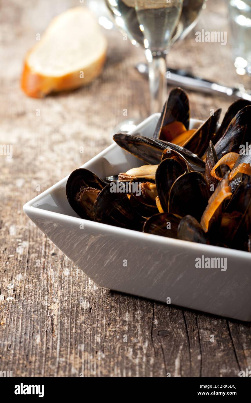 cooked mussels on dark wood Stock Photo