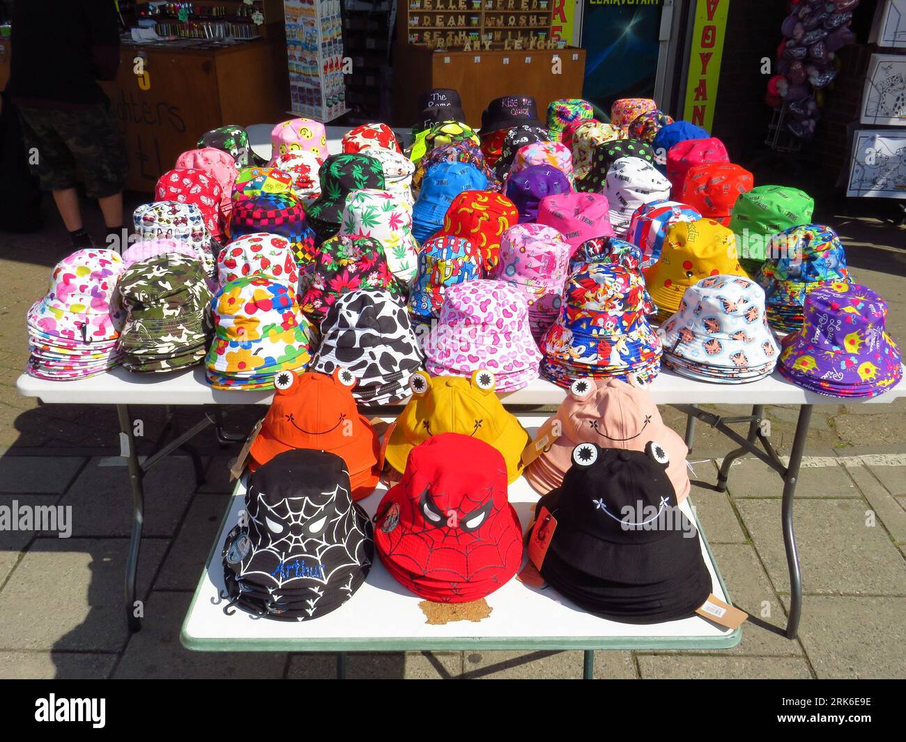 A stall with an assortment of colored hats for sale Stock Photo