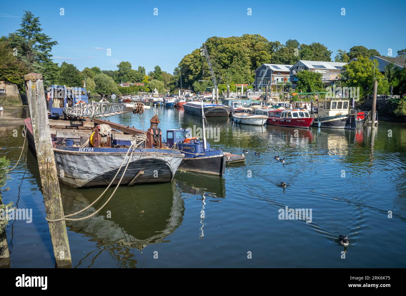 Pleasure boats and barges moored on the River Thames at Twickenham next to Eel Pie Island to the west of London, UK. Stock Photo