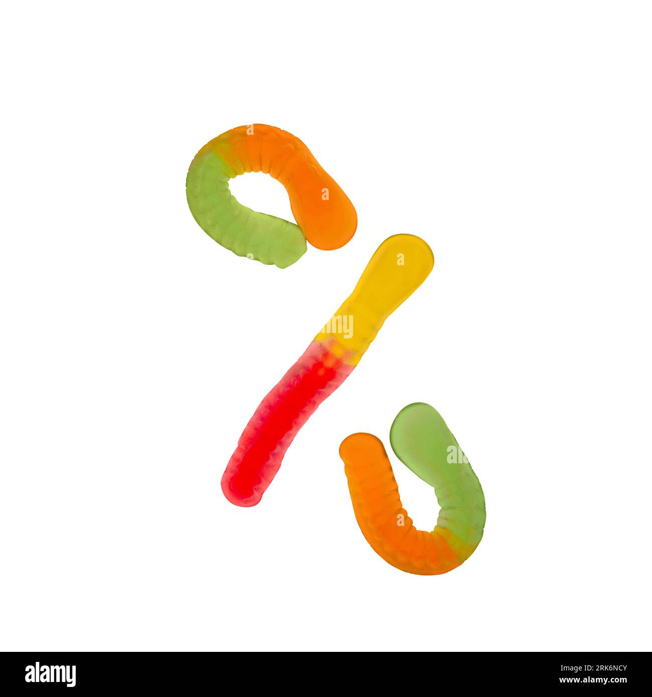 Percent sign made of gummi worms and isolated on white background. Food