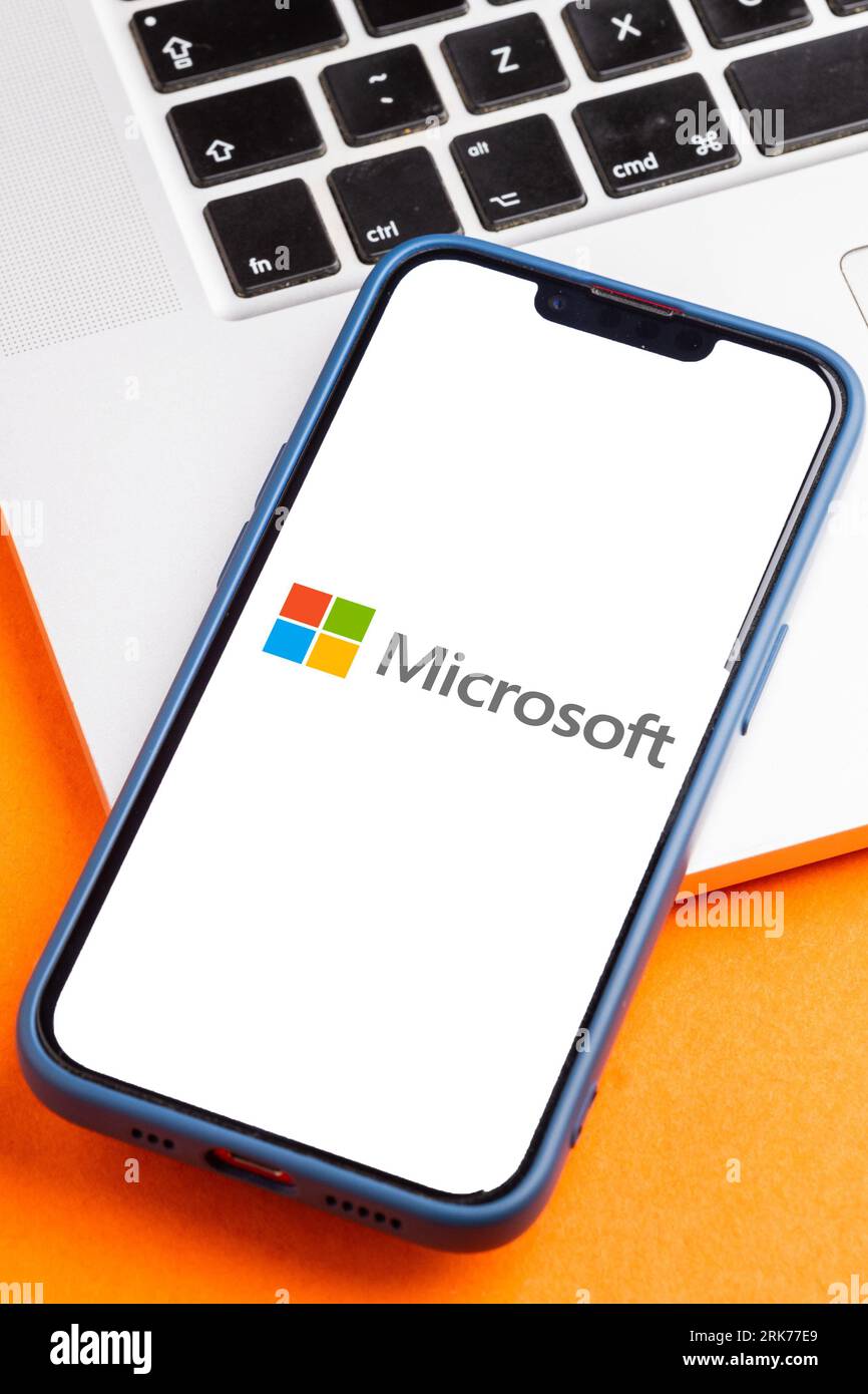 A modern smartphone screen displaying the Microsoft logo. Stock Photo