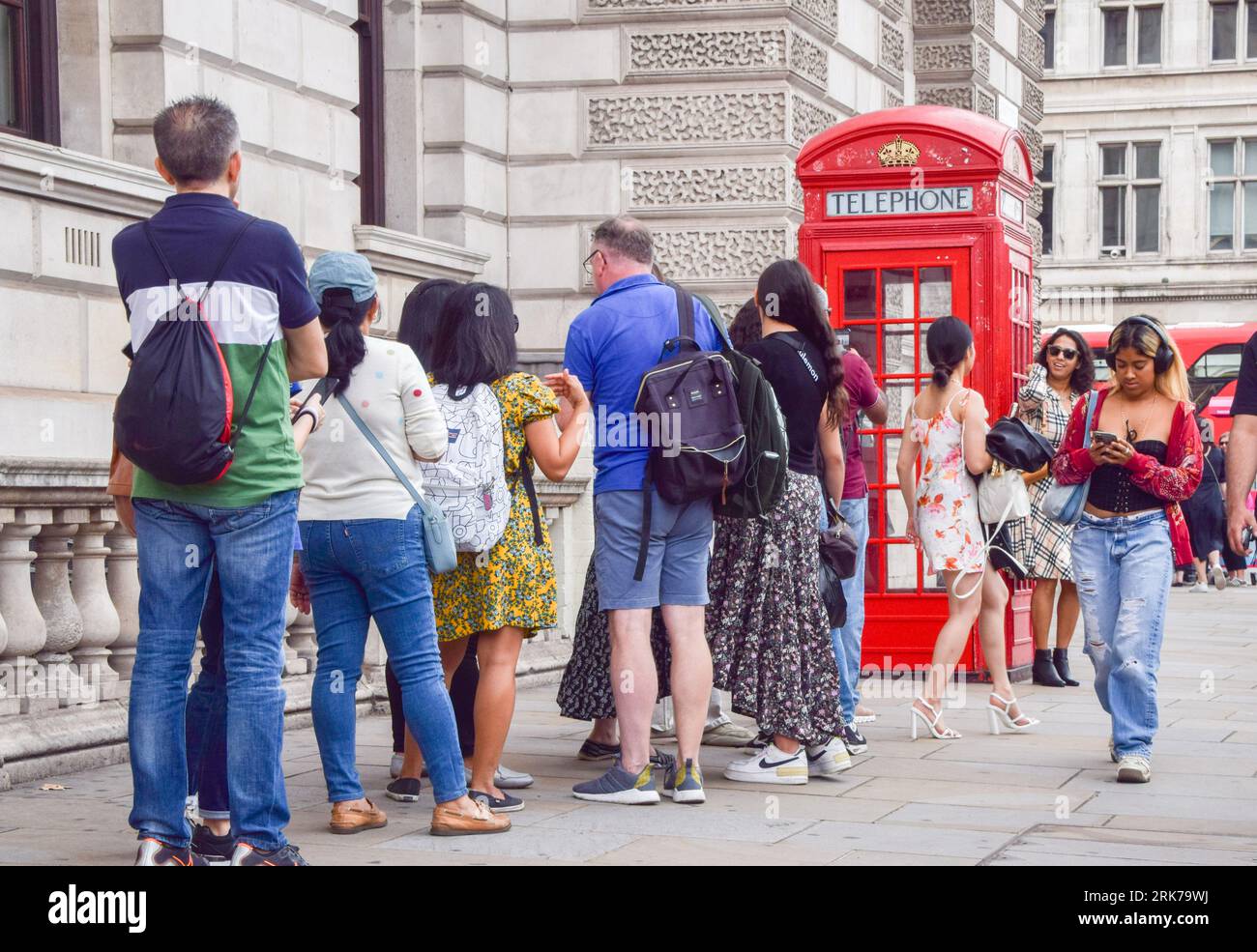 London, UK. 24th August 2023. Tourists queue to take selfies next to a
