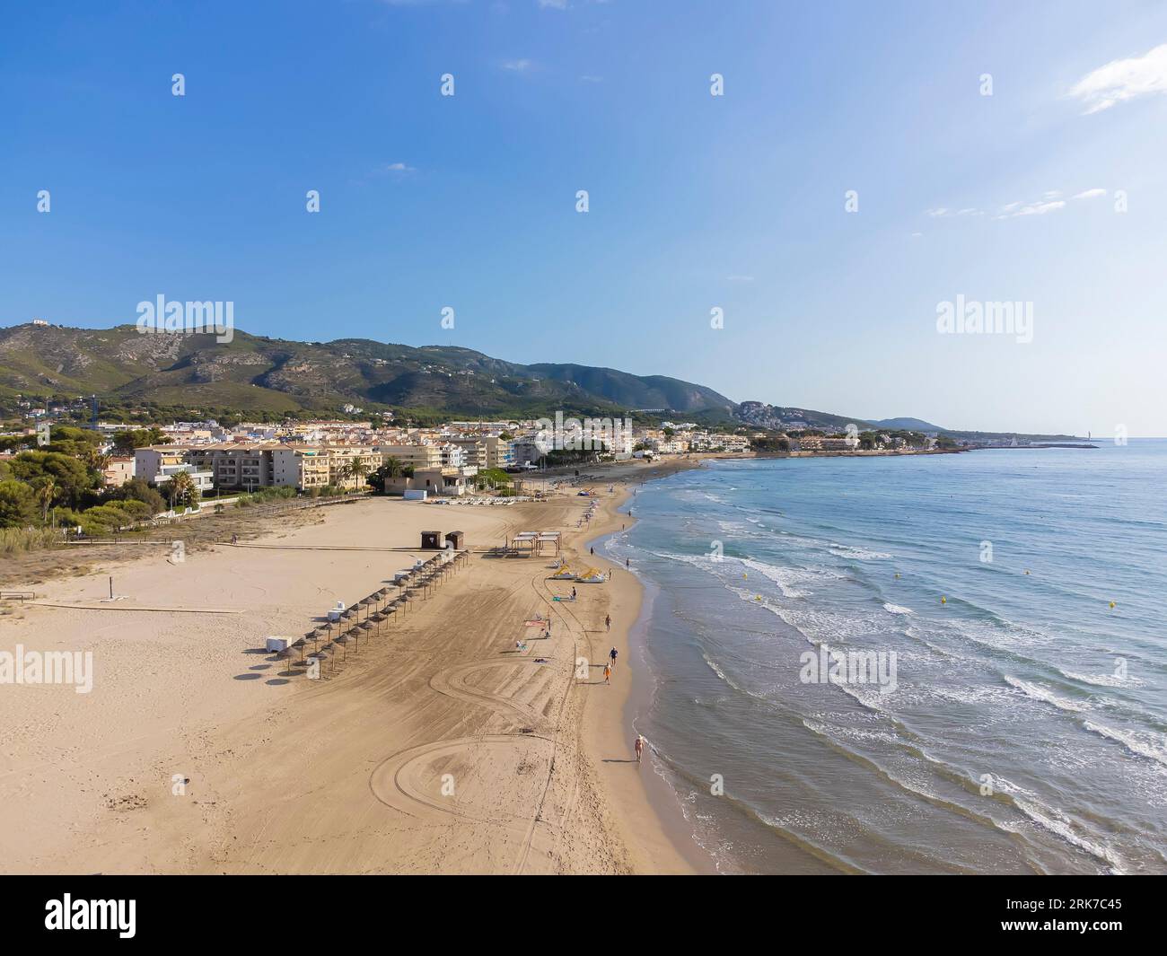 drone view of the beach of El Cargador in Alcober with the Sierra de Irta Natural Park in the background, aerial view, horizontal Stock Photo