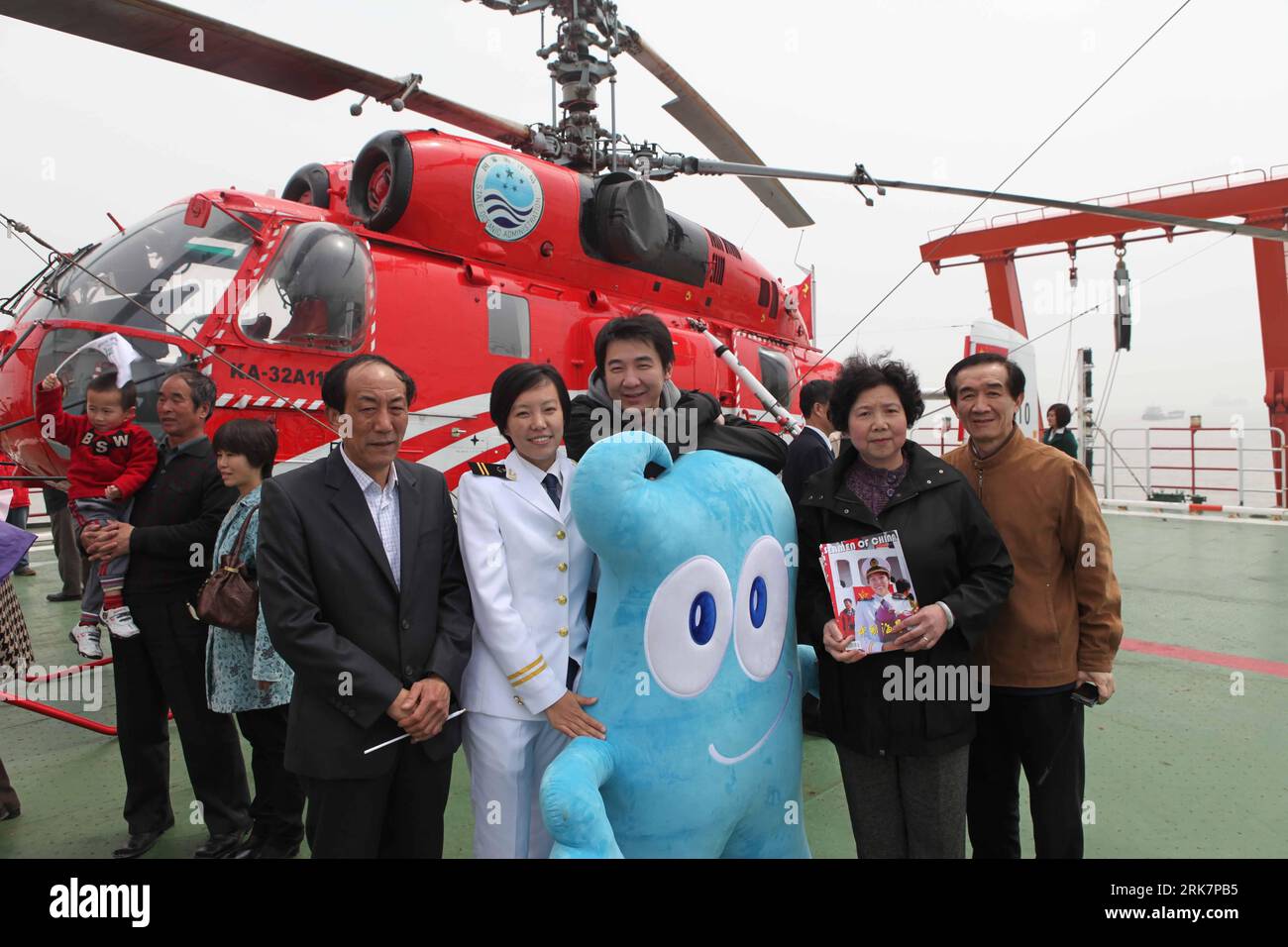 (100411) -- SHANGHAI, April 11, 2010 (Xinhua) -- People pose for a group photo with Haibao, the mascot of the 2010 Shanghai World Expo, aboard the Xuelong (Snow Dragon) icebreaker upon its arrival at the harbour of Shanghai, east China, April 10, 2010. China s 26th Antarctic expedition team aboard the Xuelong (Snow Dragon) icebreaker return to its base in Shanghai Saturday morning after finishing 12 scientific research projects covering remote sensing, icebergs, biology, physics, etc. This expedition had the biggest staff since China started Antarctic missions in 1984. The 249 staff completed Stock Photo