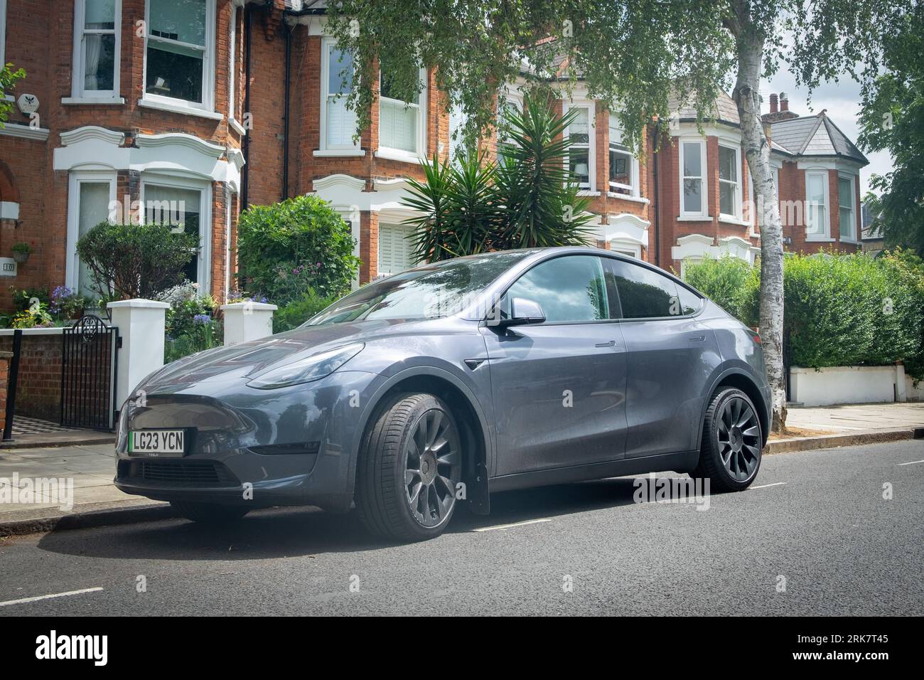 LONDON- JULY 11, 2023: Tesla Model Y parked on suburban British street Stock Photo