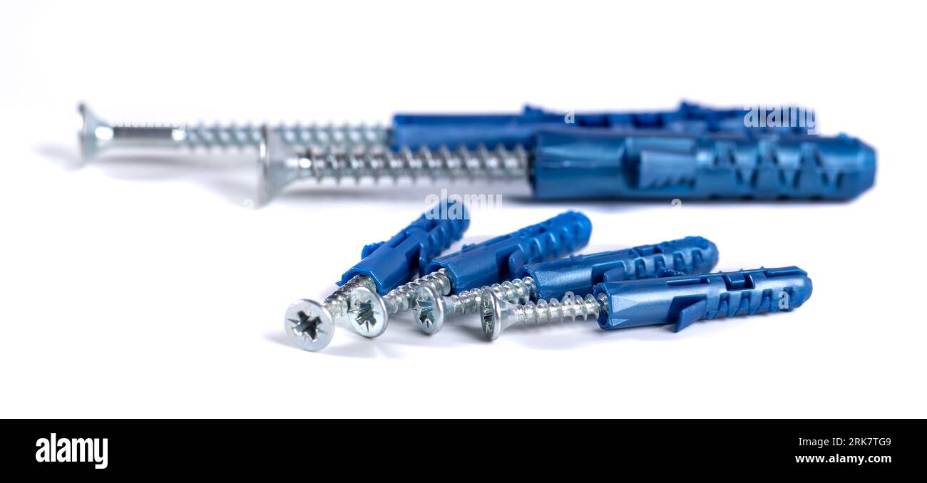 Metal screws and gray plastic dowel isolated on white Stock Photo - Alamy