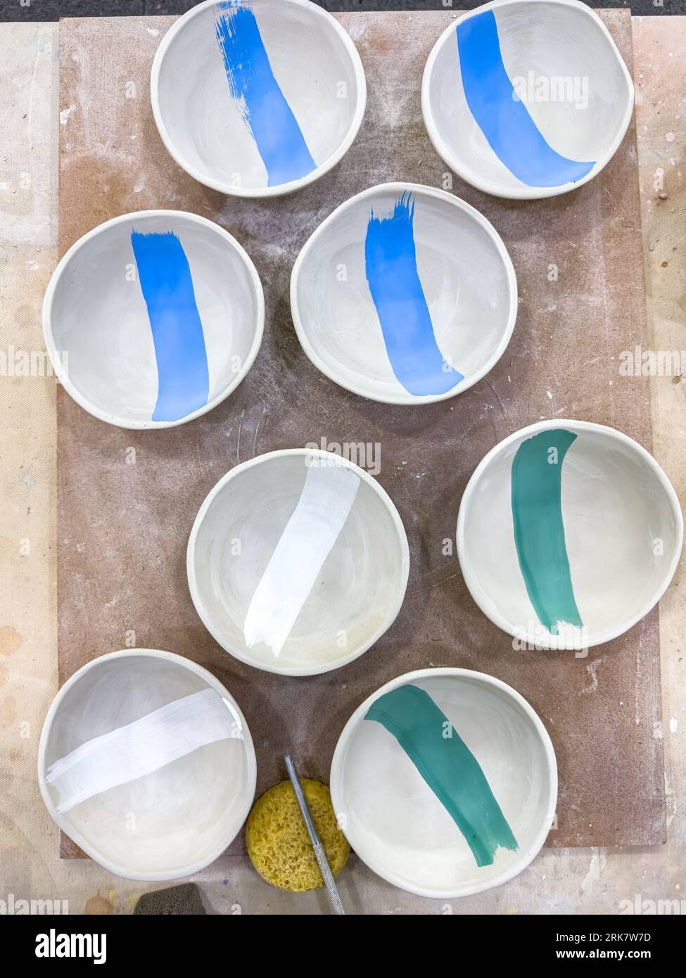 A selection of greenware ceramics bowls decorated with underglaze and