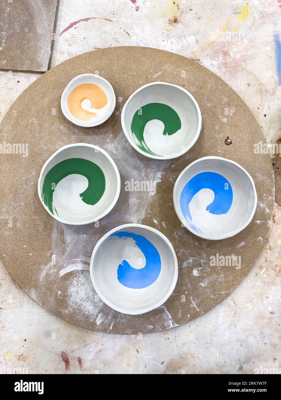 A selection of greenware ceramics bowls decorated with underglaze and