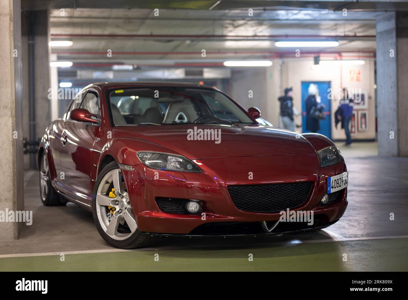 A nice tuned maroon red Mazda RX8 in the dark garage Stock Photo