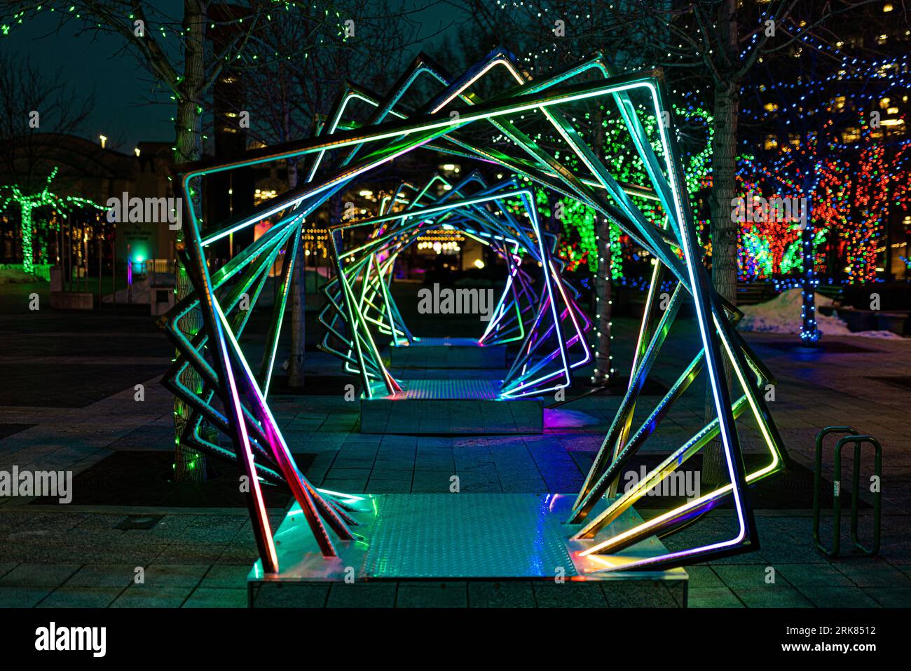 A dazzling neon display of rotating squares illuminates the night sky