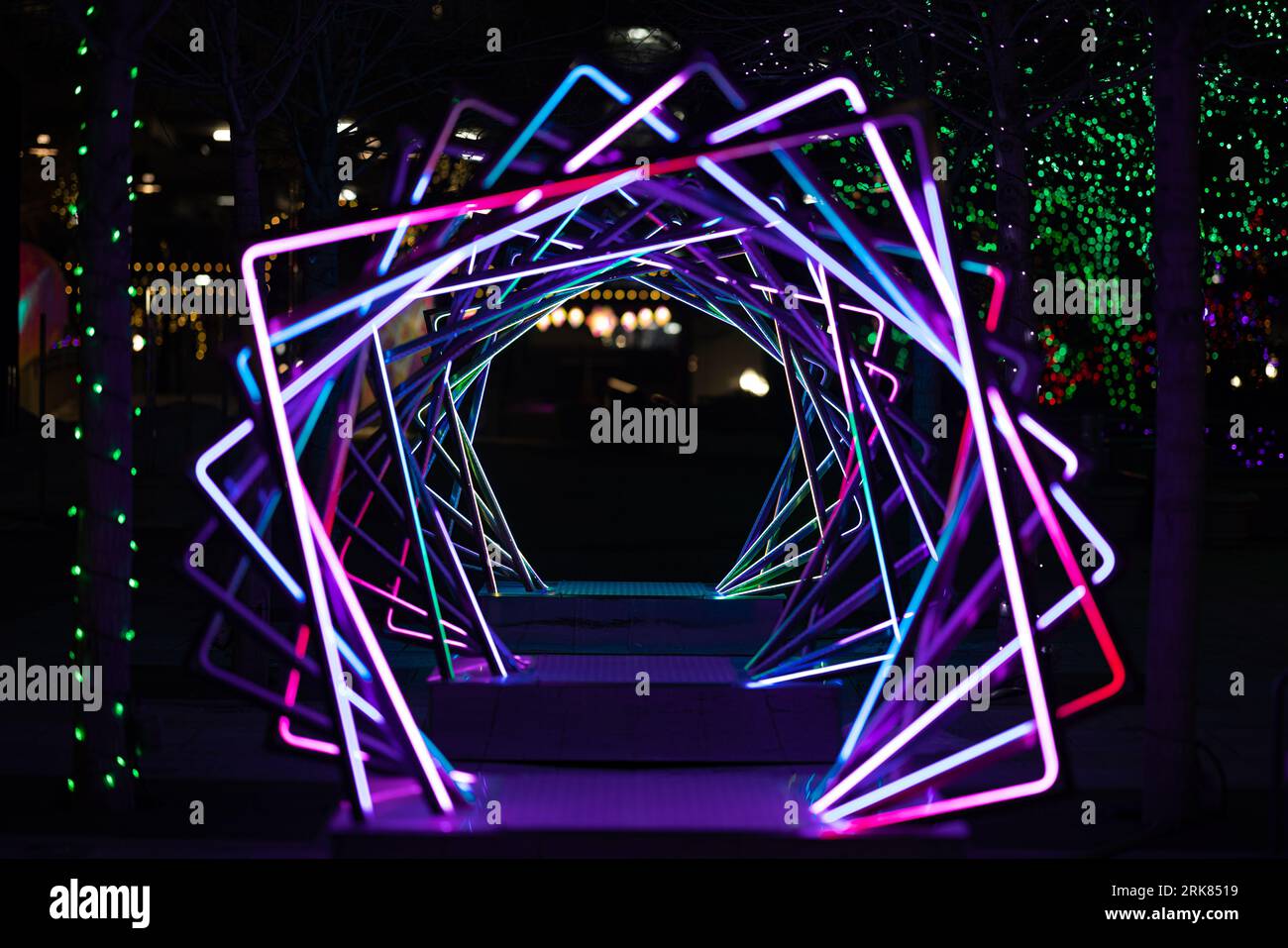 A dazzling neon display of rotating squares illuminates the night sky ...