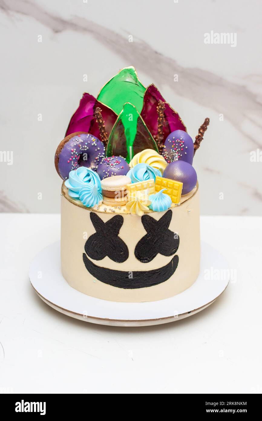 Marshmallow pop artist inspired cake. Decorated with donuts, lollipops