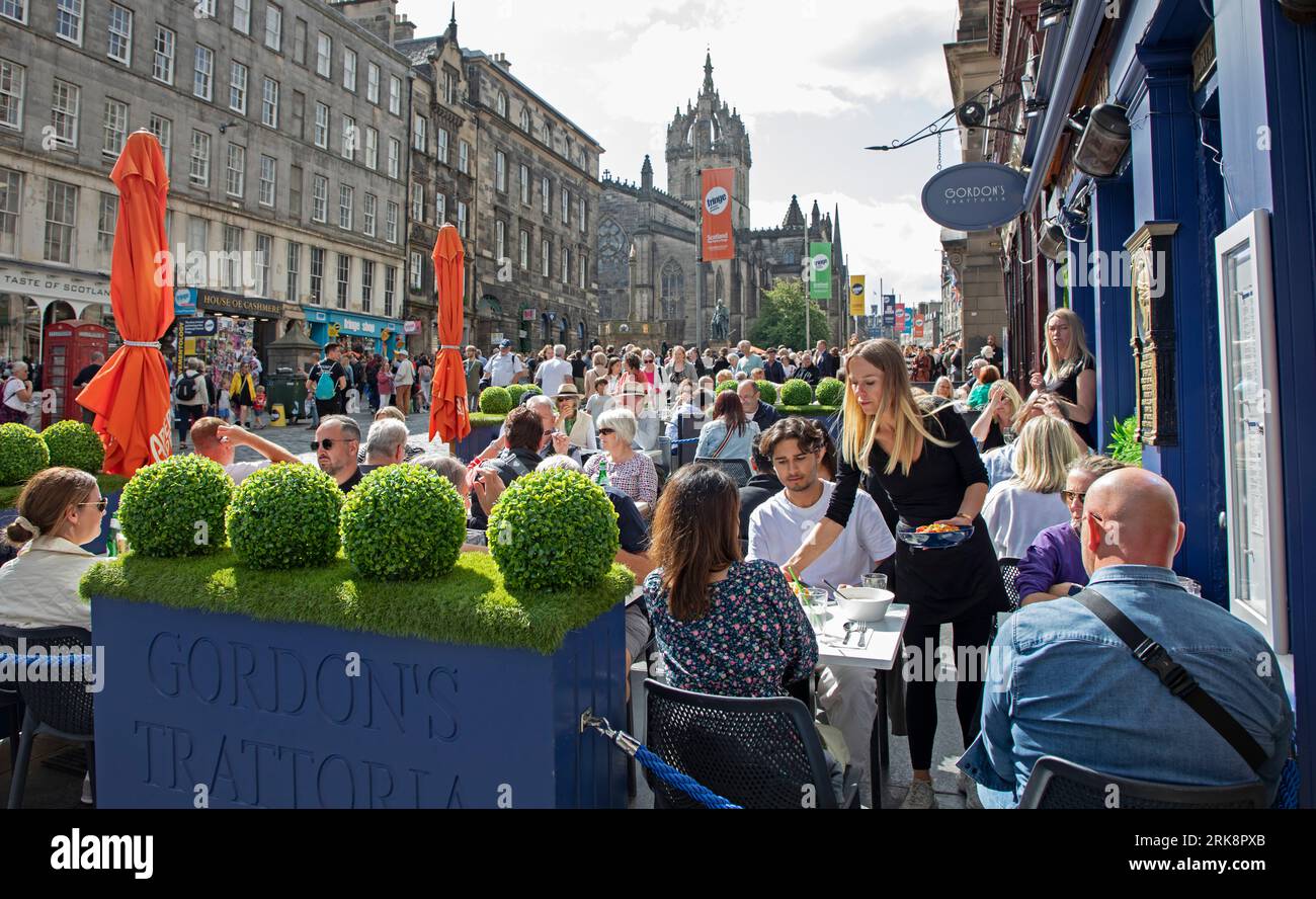 Royal Mile, Edinburgh, Scotland, UK. 24 August 2023.  Final sunny Thursday for street performers and those seeking entertainment on the High Street of the capital city. Streets are quiter than would be expected allowing more room for people to move around. Temperature around 18 degrees centigrade. Pictured:Gordon's Trattoria doing good business in the sunshine. Credit: Archwhite/alamy live news. Stock Photo