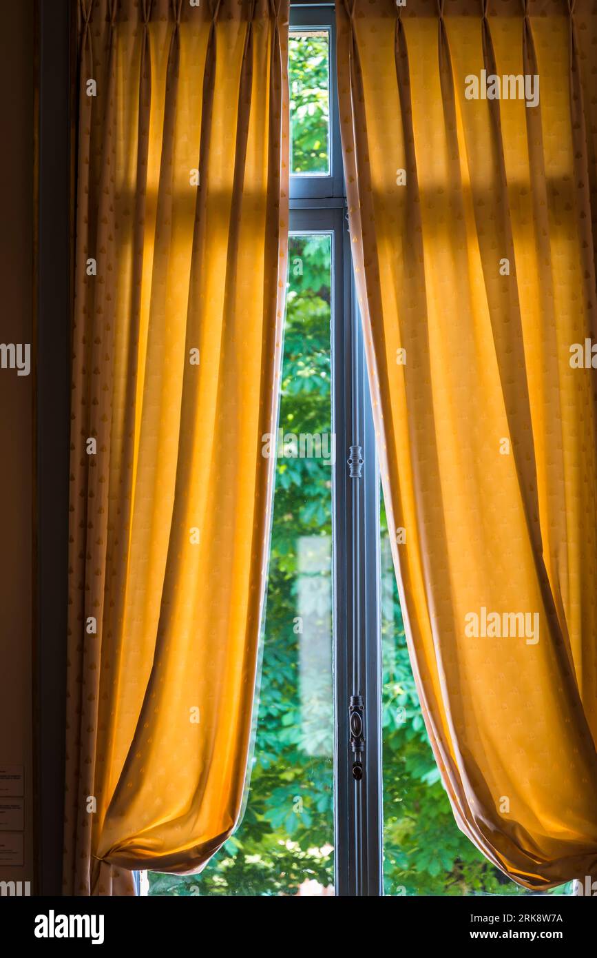 Window with semiopened yellow curtains in an old house Stock Photo Alamy