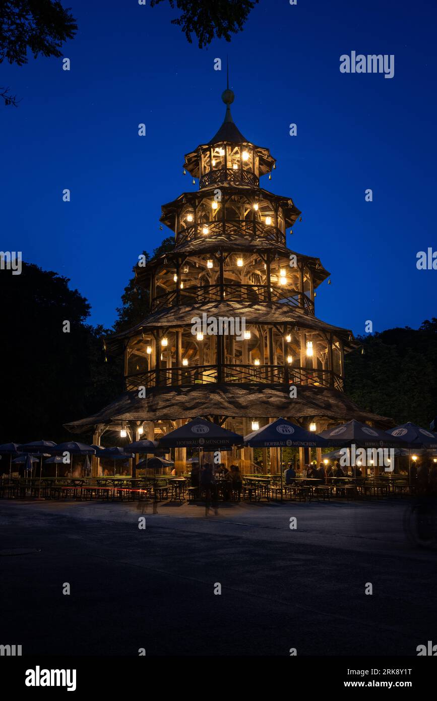 Munich, GERMANY - August 19, 2023: The Chinese Tower at the beer garden of the same name in the English Garden in Munich, Germany, at dawn / blue hour Stock Photo