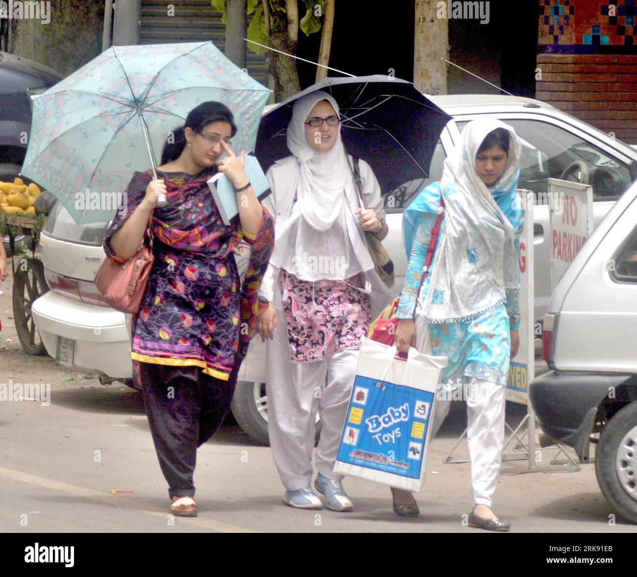 Bildnummer: 54104428  Datum: 03.06.2010  Copyright: imago/Xinhua (100603) -- LAHORE, June 3, 2010 (Xinhua) -- Girls hold umbrella to protect themselves from hot weather in eastern Pakistani city of Lahore on June 3, 2010. Heat wave in Pakistan has killed at least 18 since the beginning of May. Authorities have warned to stay out of the midday sun. (Xinhua Photo/Jamil Ahmad) (cl) (7)PAKISTAN-LAHORE-HEAT WAVE PUBLICATIONxNOTxINxCHN Gesellschaft Hitze Hitzewelle Kinder kbdig xdp 2010 quadrat o0 Schirm Sonnenschutz o00 Sonnenschirm    Bildnummer 54104428 Date 03 06 2010 Copyright Imago XINHUA  Lah Stock Photo