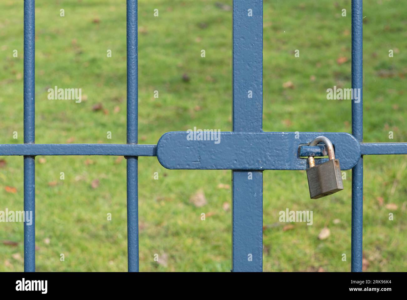 The gate is locked with a metal padlock. Close up Stock Photo