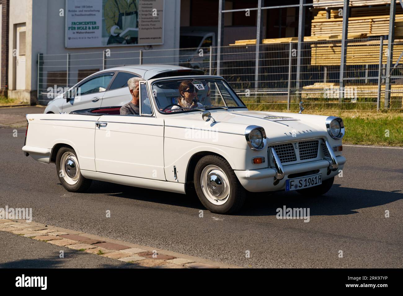 Waltershausen, Germany - June 10, 2023: A Triumph Herald Coupe is driving along the city street. Stock Photo