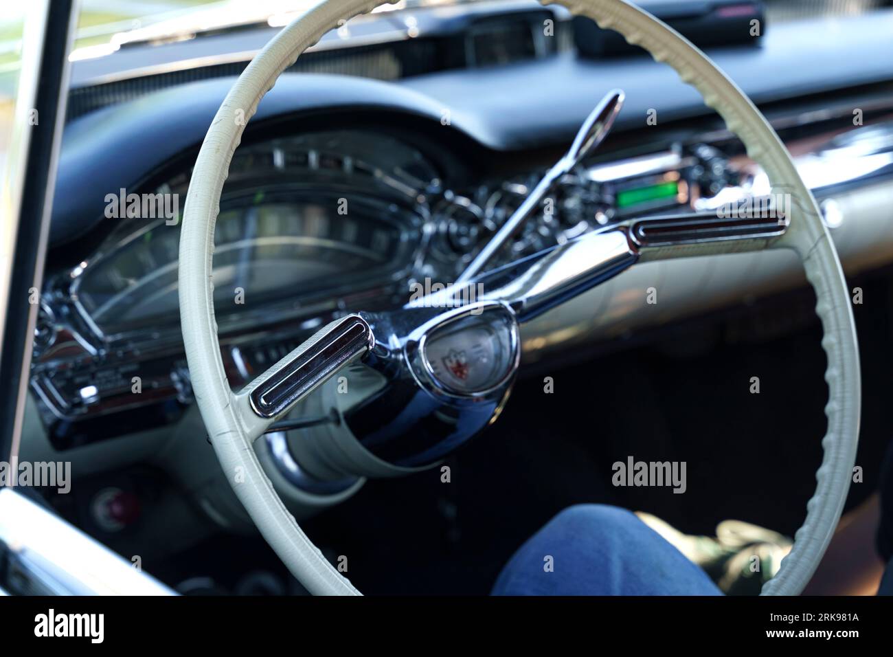 Waltershausen, Germany - June 10, 2023: White steering wheel of a vintage American car Oldsmobile Rocket Super 88. The dashboard in the background is Stock Photo