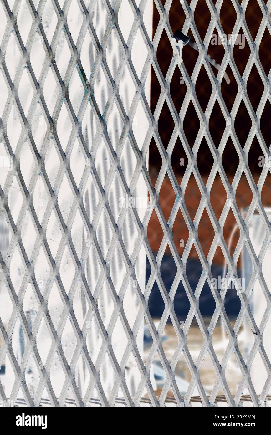 A typical metal chain link fence with a repeating pattern of steel ...