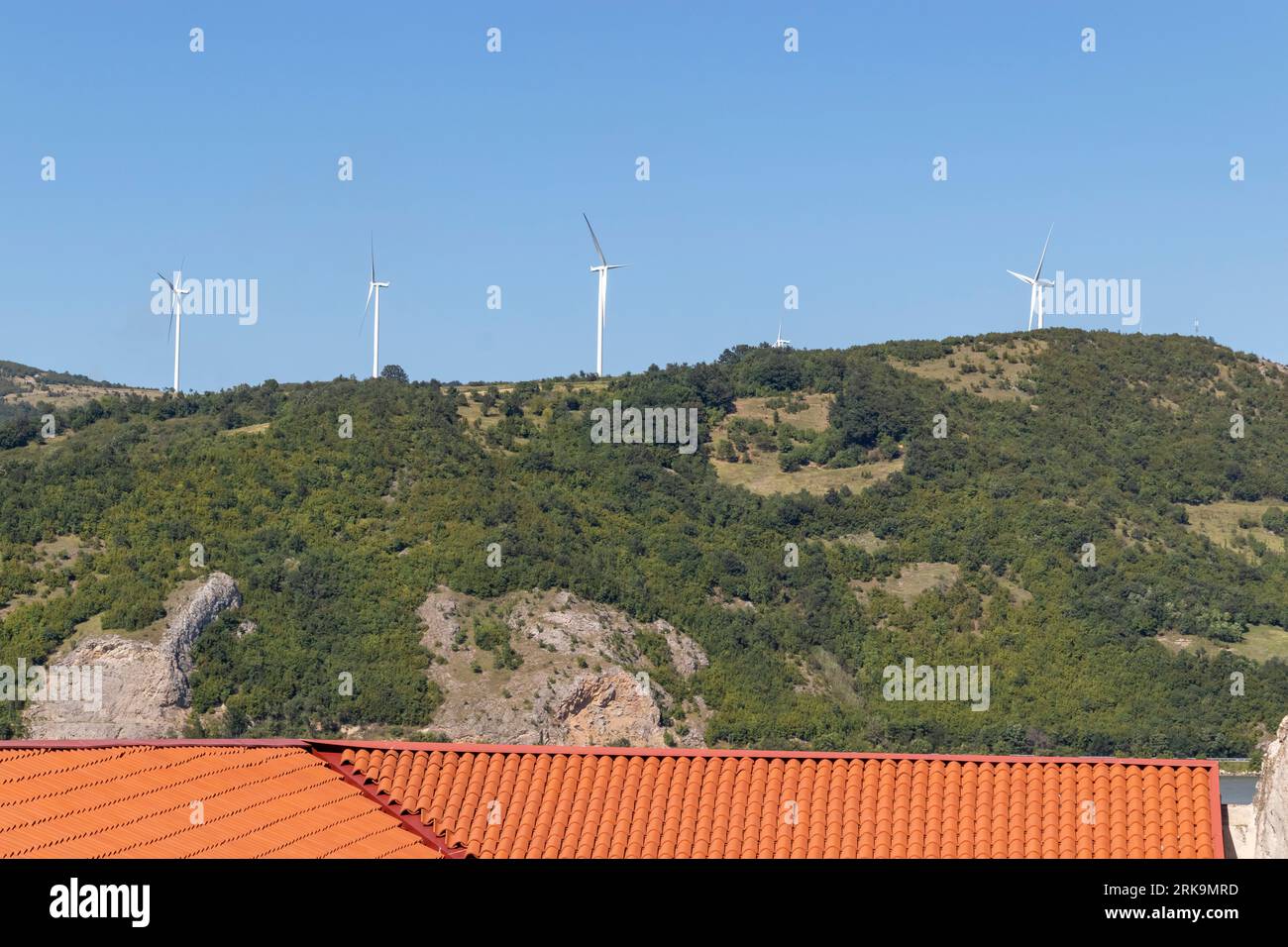 Wind turbines on hilltop and blue sky Stock Photo