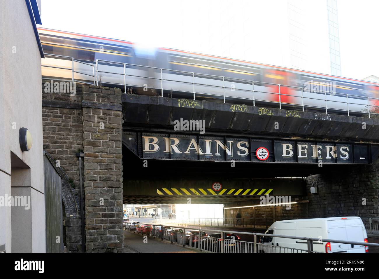 Railway bridge, Cardiff city centre with train and painted signage for ...