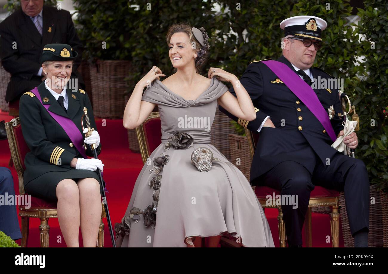 Belgian Prince Laurent (L) is pictured with Princess Claire (R) and her  daughter Princess Louise on the podium during the military parade on the  occasion of Belgium?s National Day in Brussels, Belgium