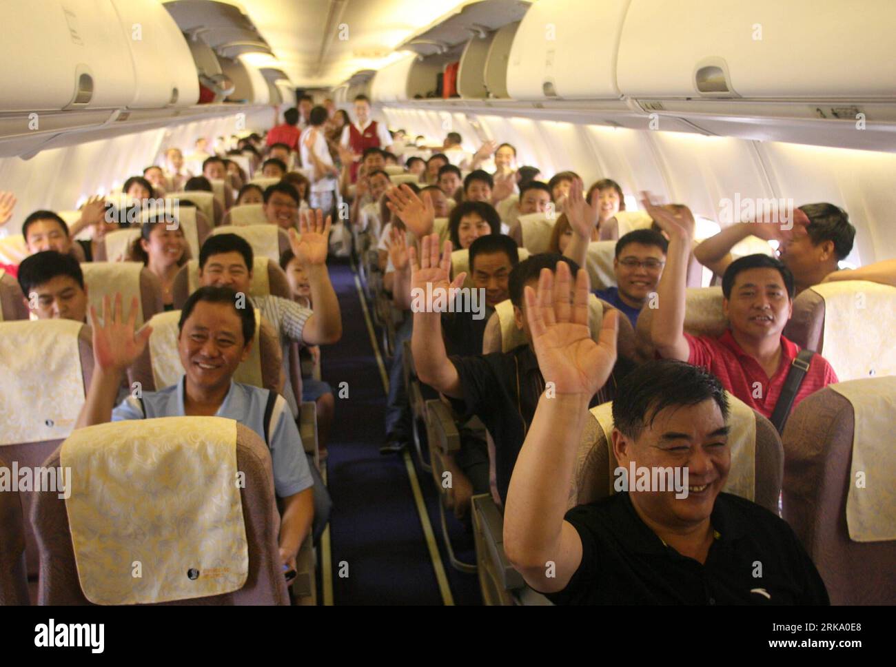 Bildnummer: 54248978  Datum: 23.07.2010  Copyright: imago/Xinhua (100723) -- JINAN, July 23, 2010 (Xinhua) -- Passengers wave their hands on the plane from Jinan to Taichung during a photo session on July 23, 2010. Shandong Airlines launched direct flights from Jinan to Taichung Friday, which is the sixth route between east China s Shandong Province and southeast China s Taiwan. The first flight reached Ching Chuan Kang Airport in Taichung at 10 o clock am. (Xinhua/Lu Chuanquan)(xzj) (3)CHINA-SHANGDONG-JINAN-TAIWAN-TAICHUNG-DIRECT FLIGHT(CN) PUBLICATIONxNOTxINxCHN Gesellschaft Verkehr Luftfahr Stock Photo