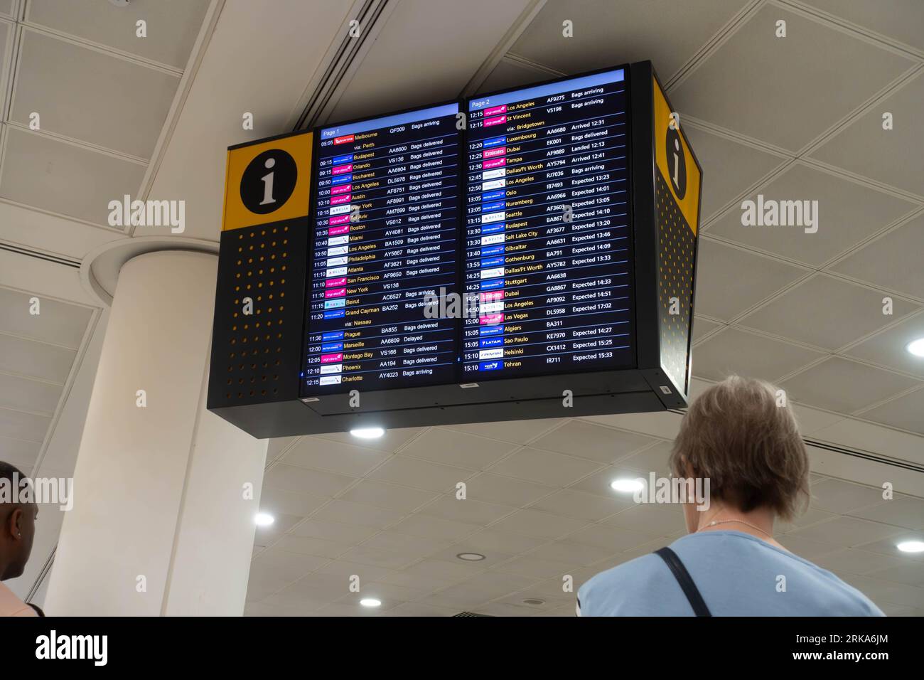 An arrivals board in London Heathrow Airport Terminal 3 giving information of when flights arrive. Stock Photo
