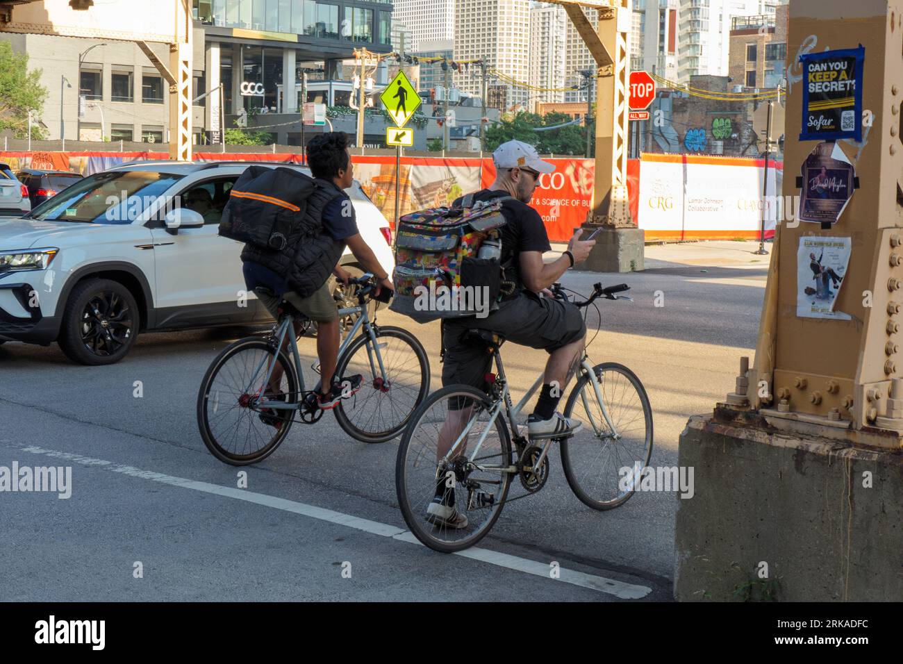 Restaurant food delivery cyclists. Fulton Market District, Chicago, Illinois. Stock Photo