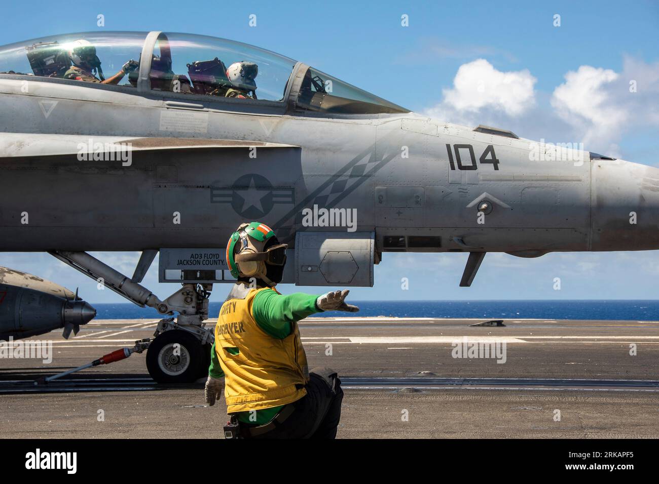 Philippine Sea, United States. 21st Aug, 2023. U.S. Navy Safety Observer AB2 Noah Moon, clears a F/A-18F Super Hornet fighter aircraft attached to the Diamondbacks of Strike Fighter Squadron 102, for launch from the flight deck of the Nimitz-class aircraft carrier USS Ronald Reagan underway, August 21, 2023 operating on the Philippine Sea. Credit: MC2 Caleb Dyal/U.S. Navy/Alamy Live News Stock Photo