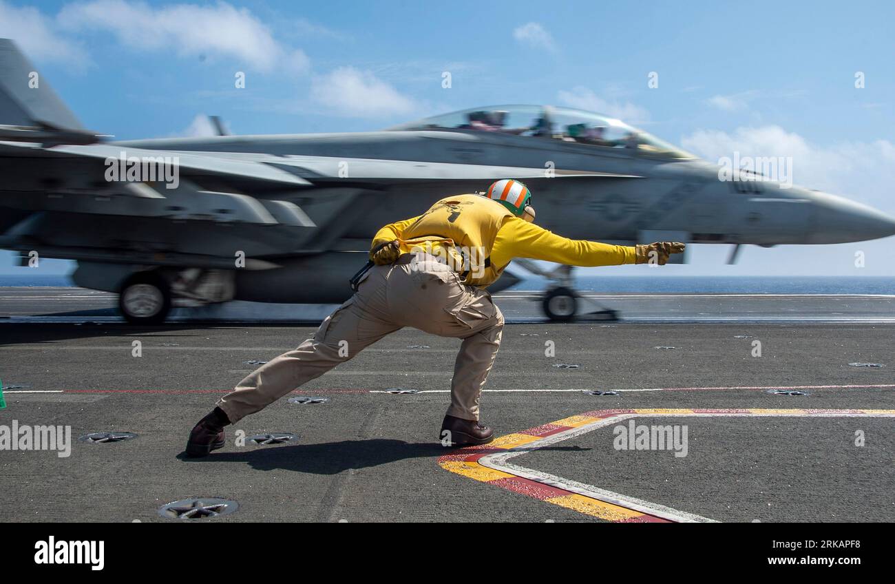 Philippine Sea, United States. 23rd Aug, 2023. U.S. Navy shooter Lt. Benjamin Schmidt, launches a F/A-18F Super Hornet fighter aircraft attached to the Diamondbacks of Strike Fighter Squadron 102, launches from the flight deck of the Nimitz-class aircraft carrier USS Ronald Reagan underway, August 23, 2023 operating on the Philippine Sea. Credit: MC3 Natasha Chevalier Losada/U.S. Navy/Alamy Live News Stock Photo
