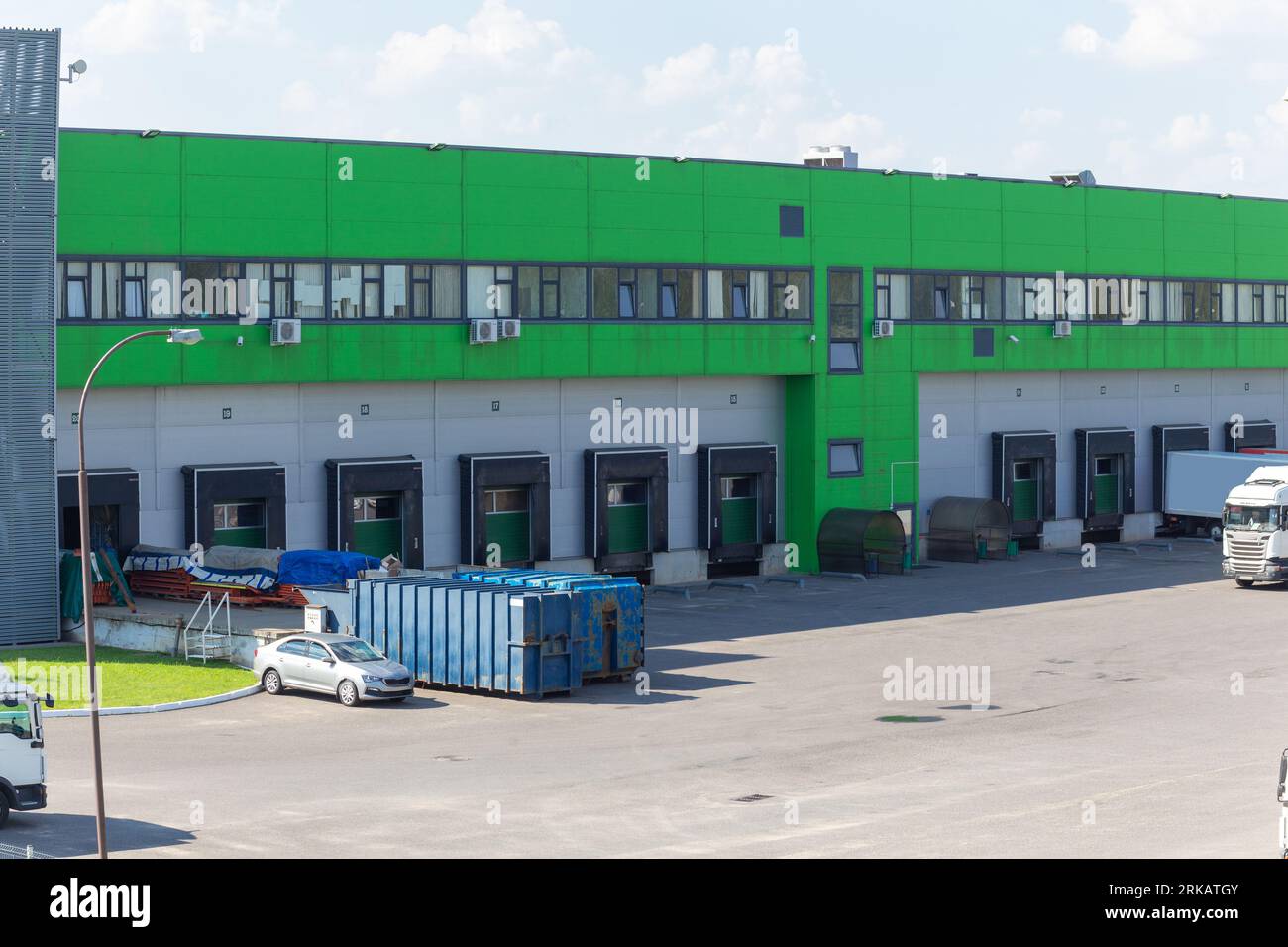 Row of loading docks with shutter doors. Warehouse gates for loading ...