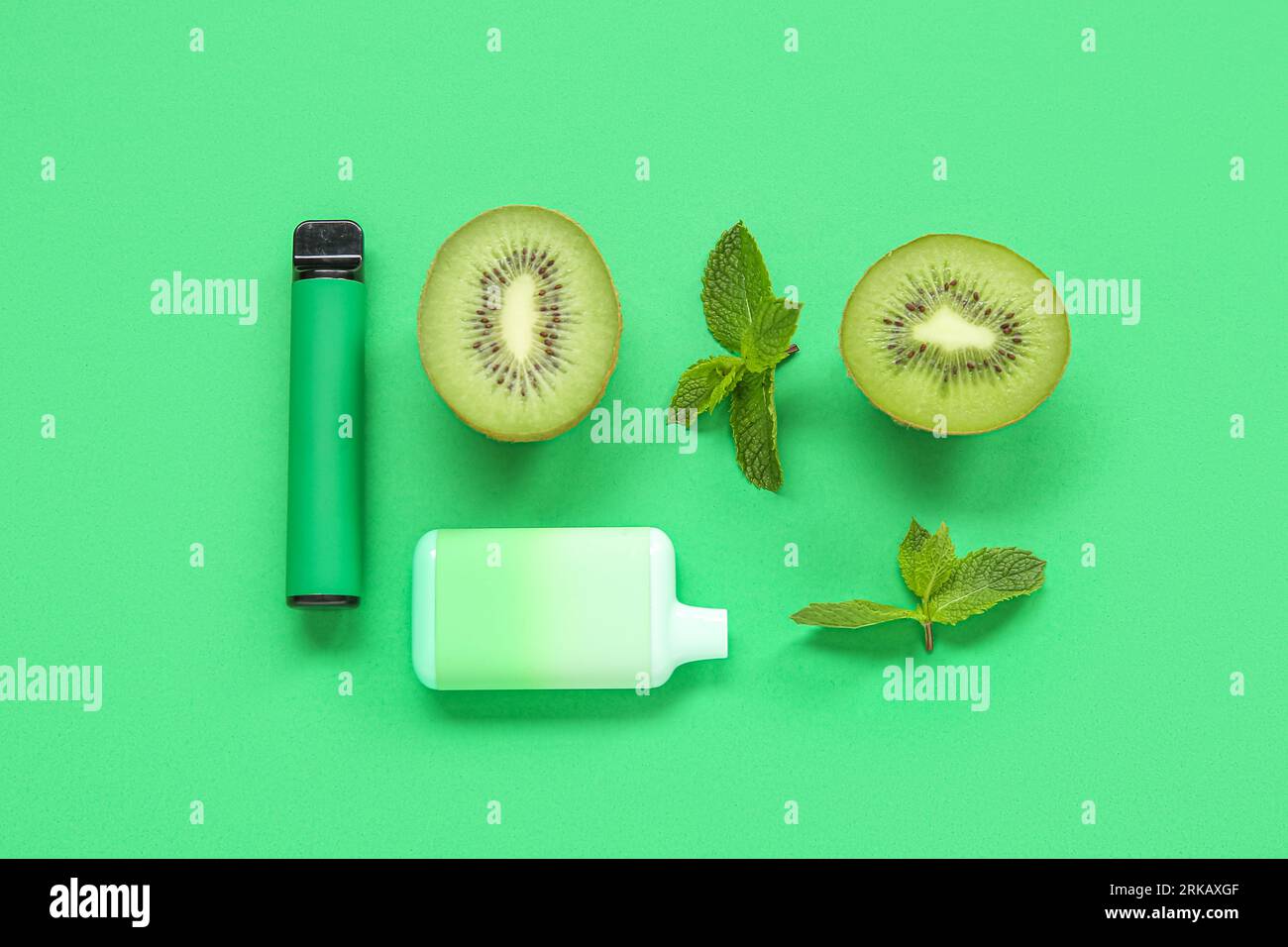 Electronic cigarettes with kiwi and mint on green background Stock Photo