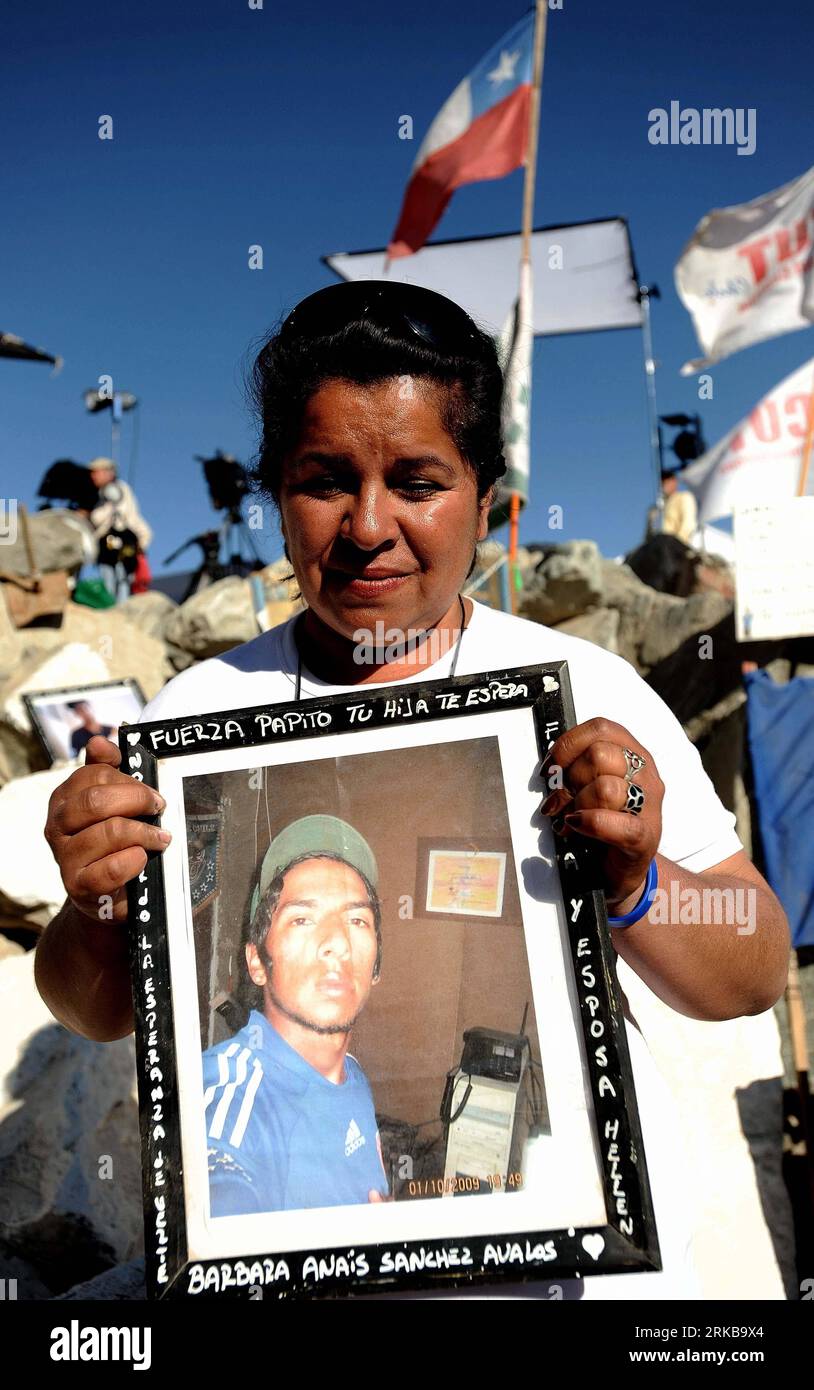 101008 -- SAN JOSE, Oct. 8, 2010 Xinhua -- Mother of Richard Villaroel who is one of the 33 miners trapped underground holds a picture of her son in San Jose mine, 800 km north of the Chilean capital of Santiago on Oct. 8, 2010. The 33 miners trapped 700 meters underground in the northern Chilean Atacama desert will be rescued next Tuesday through a 624-meter tunnel to be completed soon, Chile s Mining Minister Laurence Golborne announced on Friday. Xinhua/Jorge Villegas zw CHILE-SAN JOSE-TRAPPED MINERS-RESCUE PUBLICATIONxNOTxINxCHN Stock Photo