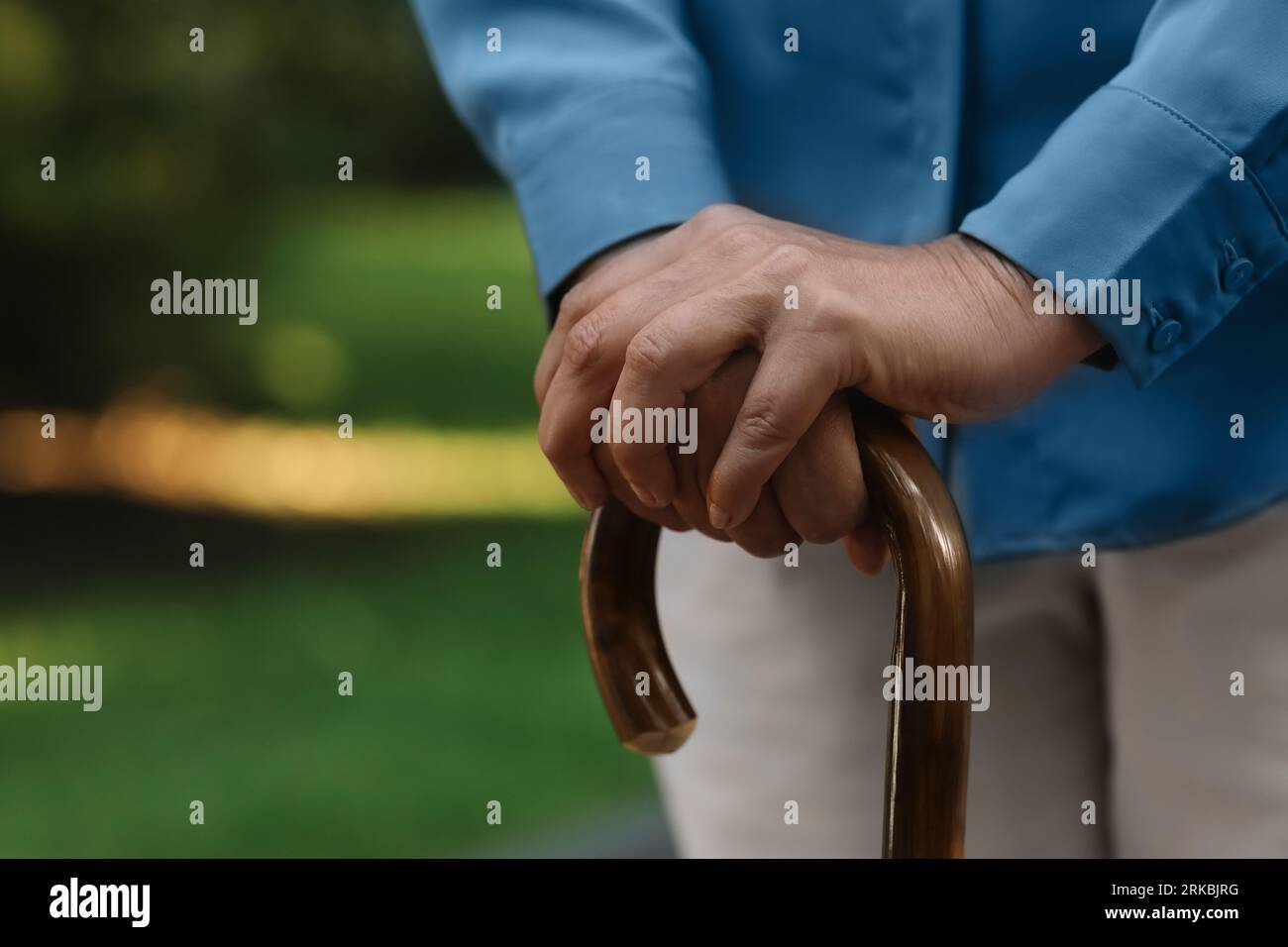 Senior woman with walking cane outdoors, closeup. Space for text Stock ...