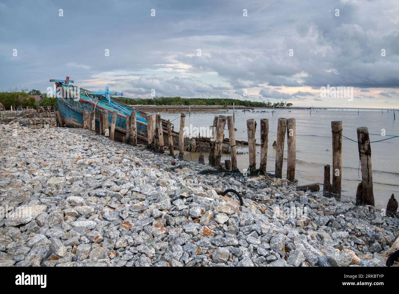 abandoned fishing boat decaying at the swampy beach Stock Photo - Alamy